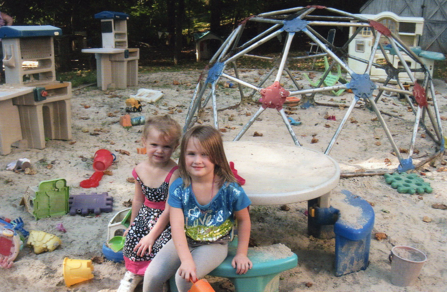 Two Girls Sitting in Playground